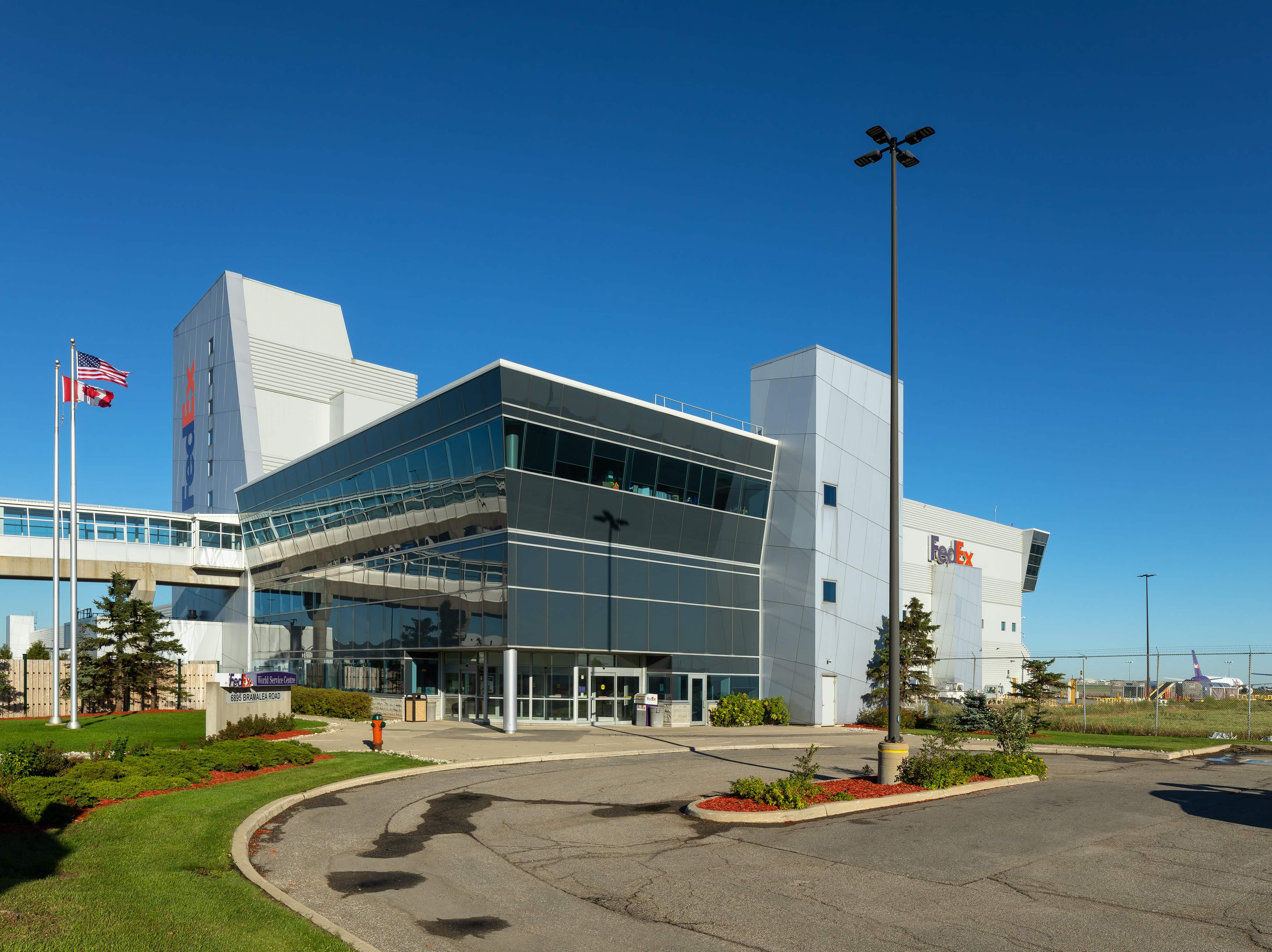 project-fedex-yyz-1-b Fedex Building with a parking lot and a US/Canada flags
