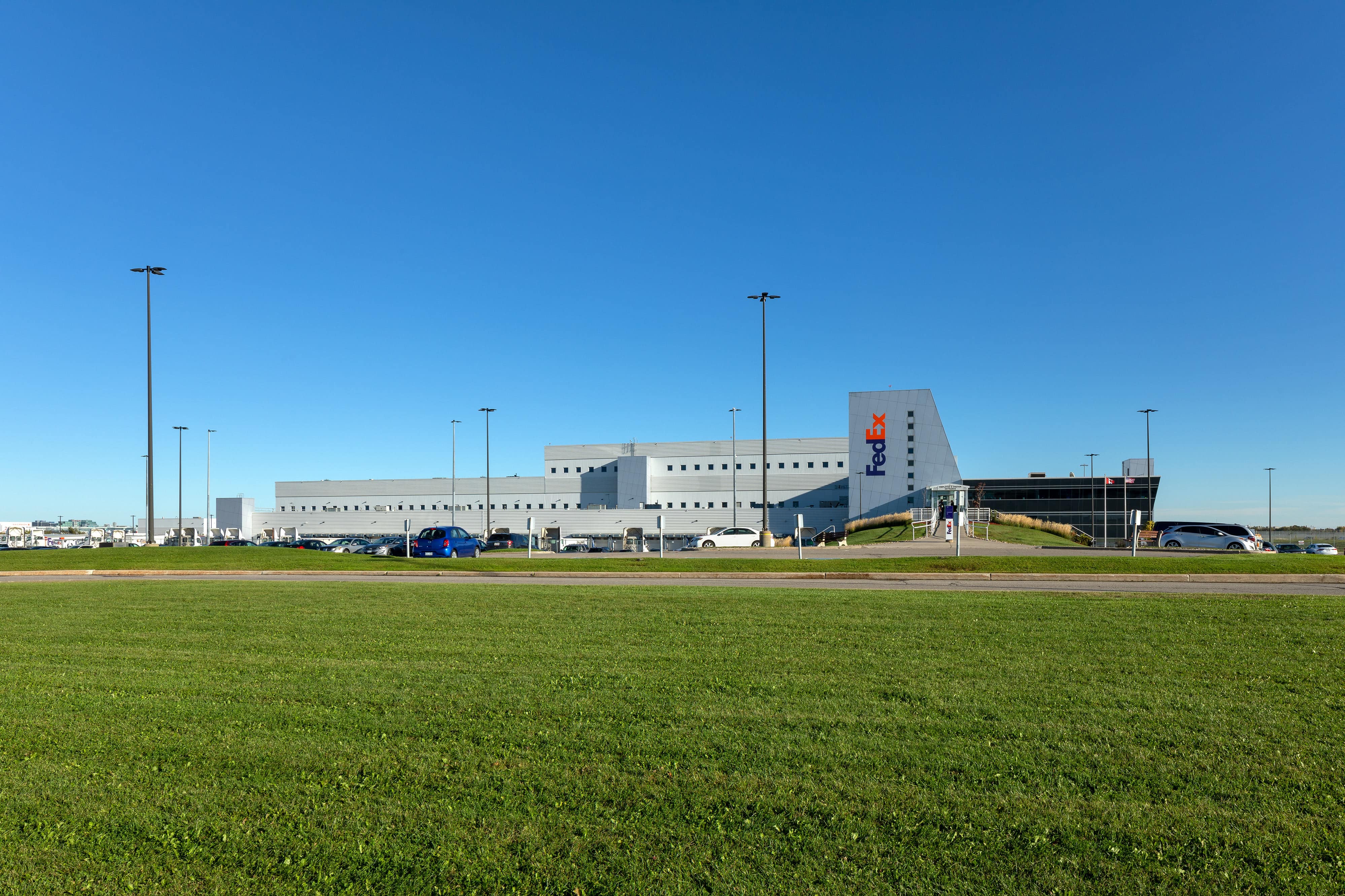 project-fedex-yyz-4-b a large building with a parking lot in the background