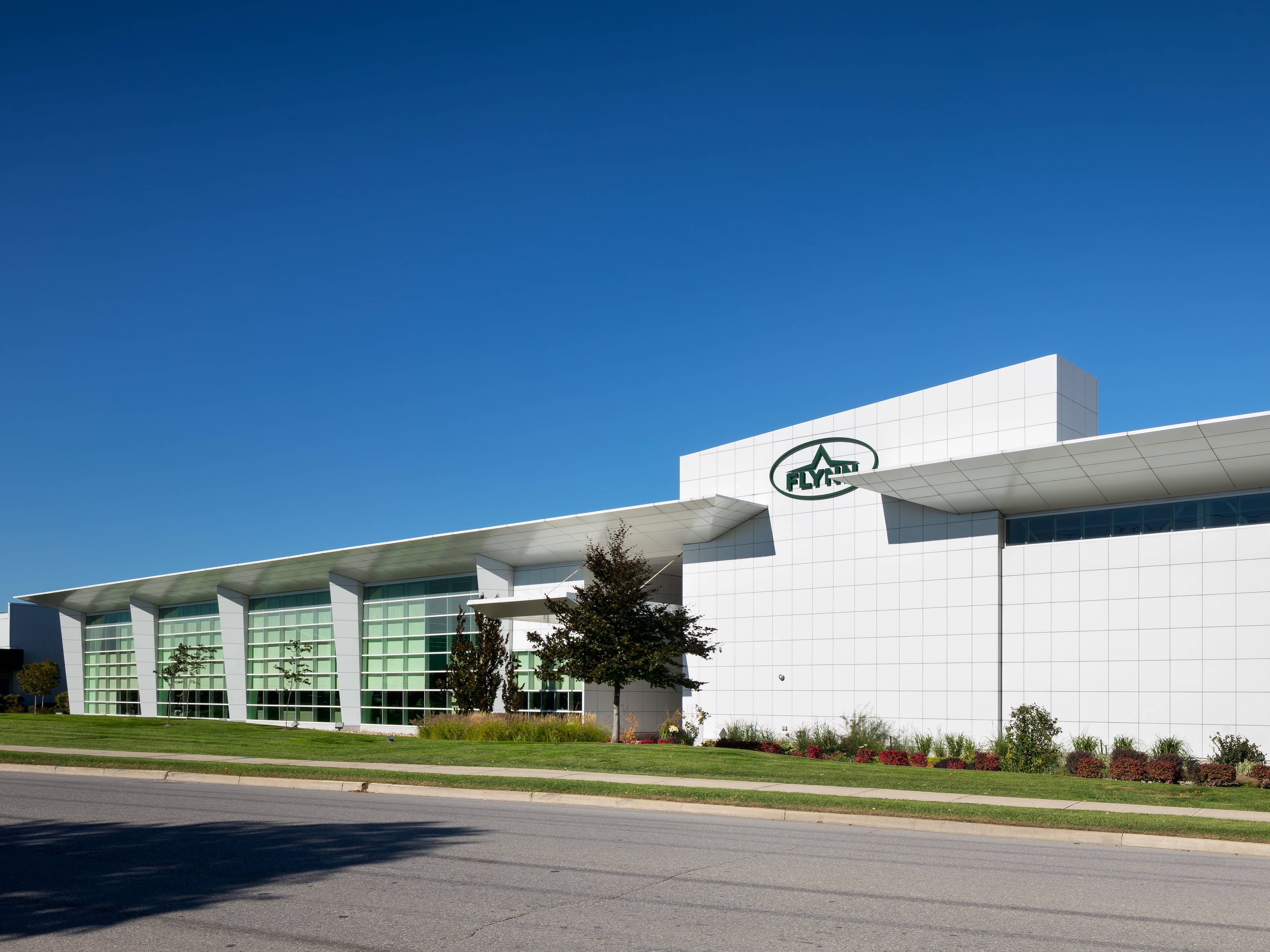 a white building with green windows